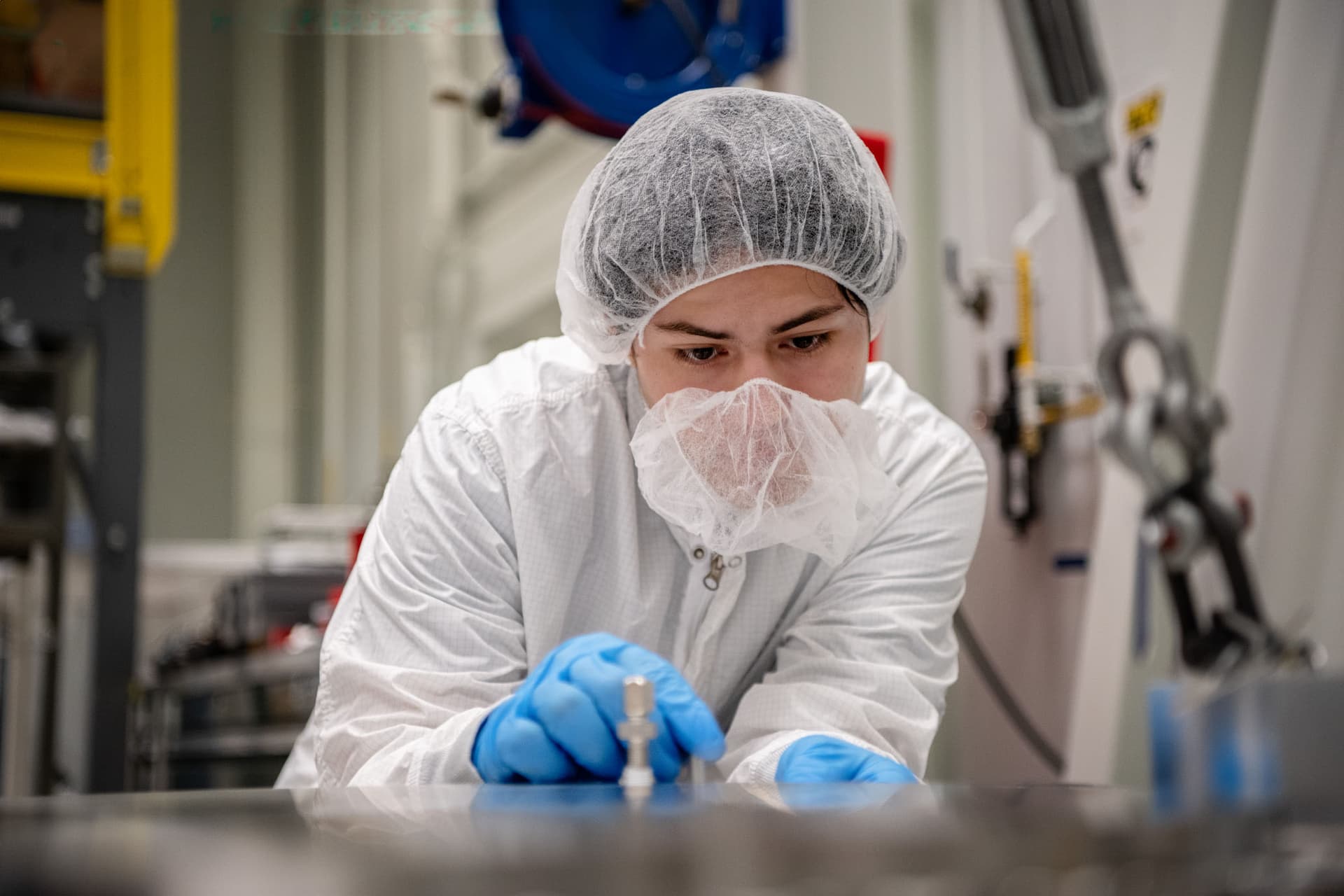 Focused bench work during hardware inspection or assembly at NASA